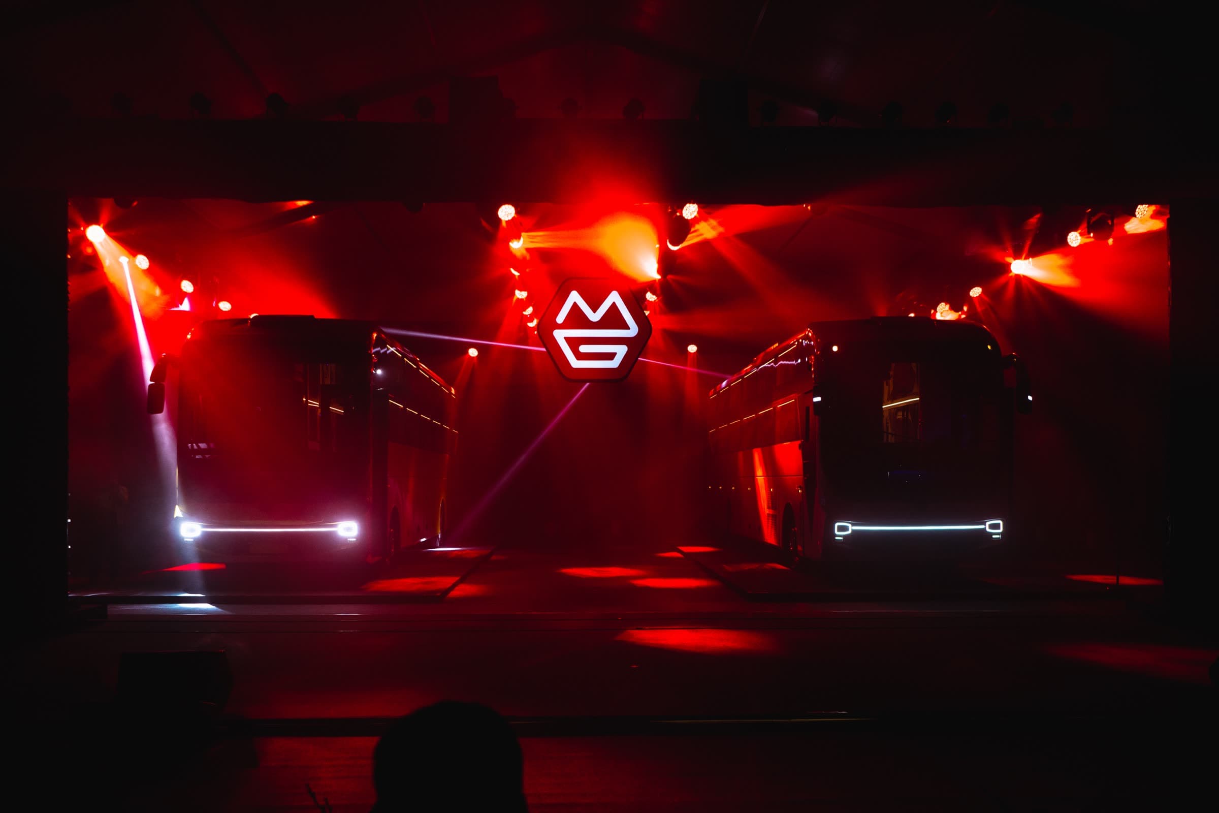 MG Group bus illuminated in red brand lighting
